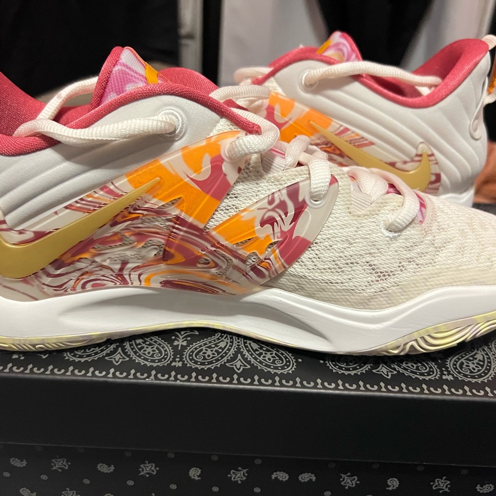 Nike White and Pink Athletic Shoes with Gold Accents